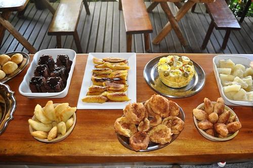 a table topped with different types of pastries and desserts at Villa Cayana in Barra Grande