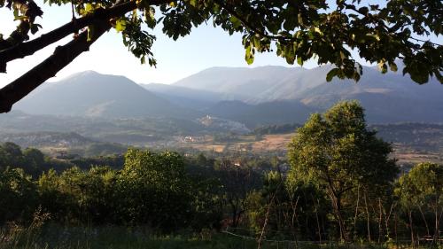 a view of a valley with mountains in the distance at Tana Libera Tutti 1 Nature, Yourself, Love in Viggianello