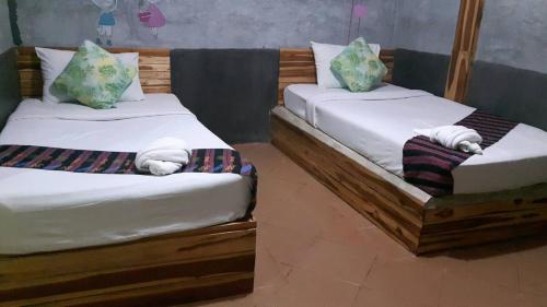 two twin beds sitting next to each other in a room at Blue Mountain Resort in Sai Yok
