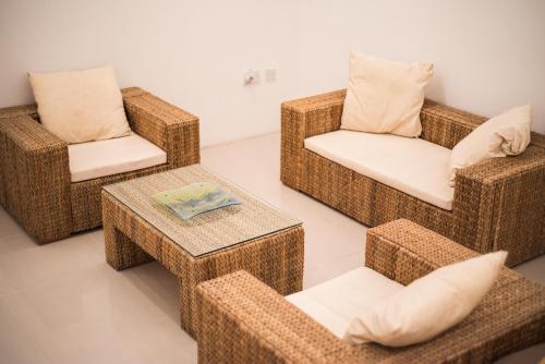 four wicker chairs and a coffee table in a room at Sant Orsla Suite in Valletta