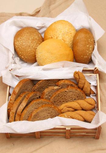 two baskets filled with different types of bread at Saint Constantine Hotel in Kos Town