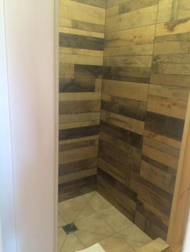 a shower with wood paneling in a bathroom at Relax villa Poduzska in Sinyak