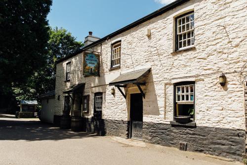 an old stone building with a sign on it at The Maltsters Arms in Totnes