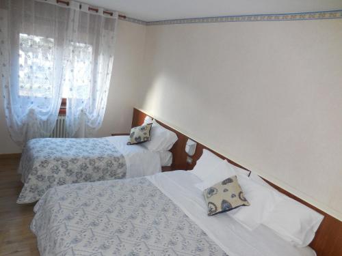 Cama o camas de una habitación en Pensione Genzianella