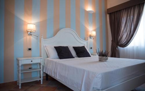 Ein Bett oder Betten in einem Zimmer der Unterkunft Anima Antiqua Relais & Spa