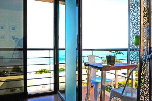 a balcony with a table and a view of the ocean at El Morche Beach in Torrox Costa