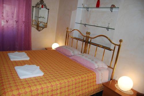 a bedroom with a bed with two towels on it at Casa MaMa Guesthouse in Genova