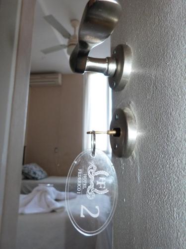 a glass doorhandle with a lock on a wall at Hotel Federico I in Concordia