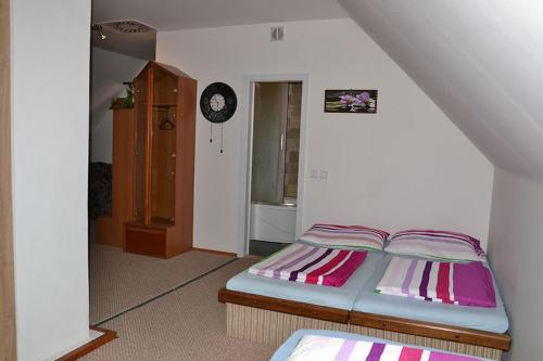 a small bedroom with a bed in a room at Penzion Pod Vápenkami in Strážnice