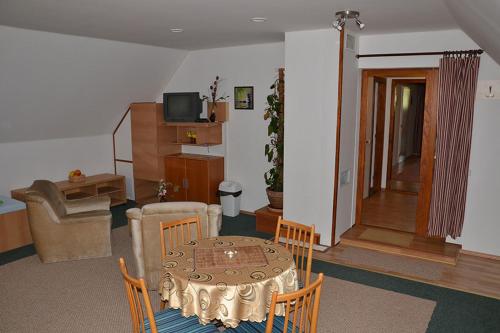 a living room with a table and chairs at Penzion Pod Vápenkami in Strážnice