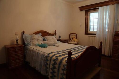 a bedroom with a bed with a stuffed animal on it at Casa do Lavrador in Casal