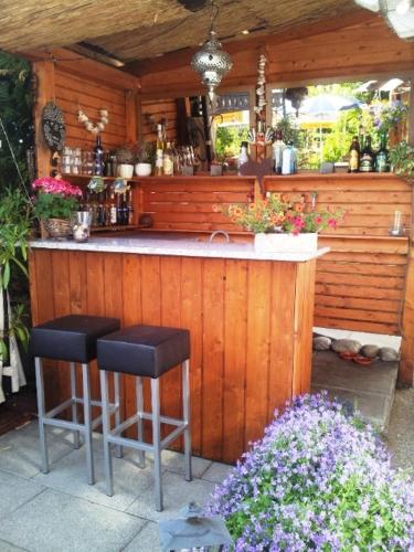 a wooden bar with two stools in front of it at B&B Fischerstüble - adults only in Hagnau