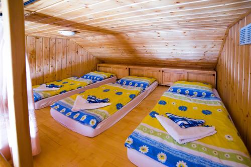 a room with three beds in a cabin at Apartments Branisko in Smokovce