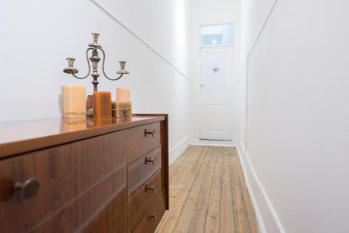 a room with a wooden dresser and a hallway at Party Zone in Lisbon
