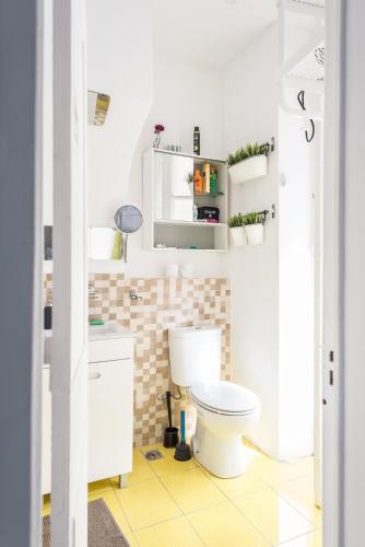 a bathroom with a white toilet in a room at Party Zone in Lisbon