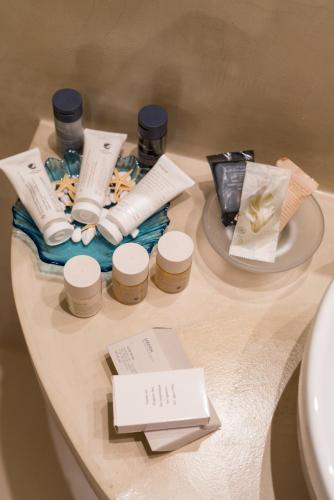 a table with a tray of products on it at Kratiras View Luxury Suites in Fira