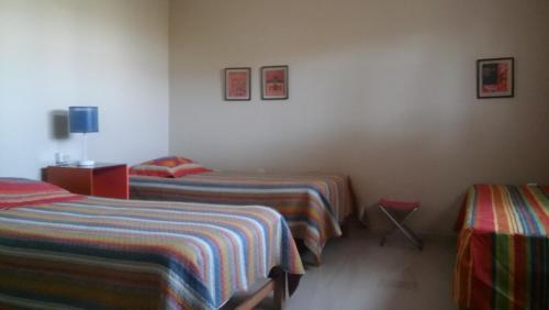 a bedroom with two beds and a tv on the wall at Huaranjapo in El Carmen