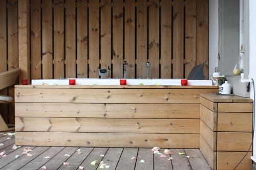 a bath tub in a room with a wooden wall at Hotel Krone Sihlbrugg in Sihlbrugg Dorf