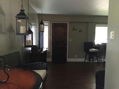 a living room with a couch and a table and a door at Secret Cottage Yellowstone 1 bd 2 beds dtwn #1 in Cody