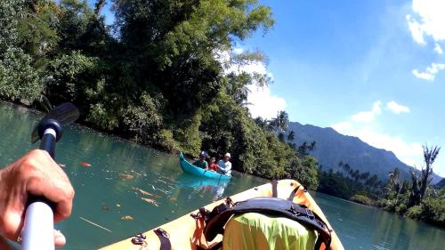 a group of people in a boat on a river at Eddie's Homestay in Lhonga