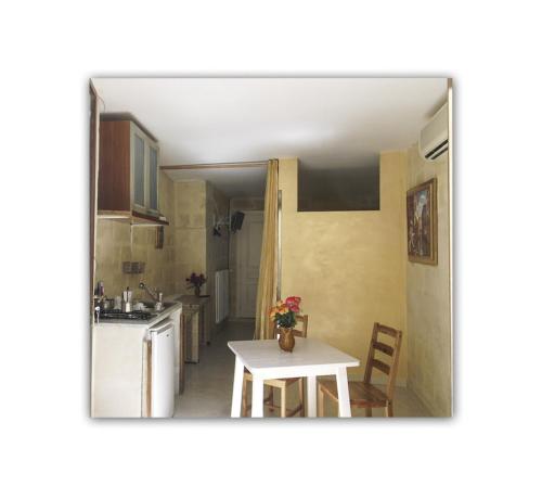a kitchen with a table and a small kitchen with a sink at casa vacanze via san pardo in Matera