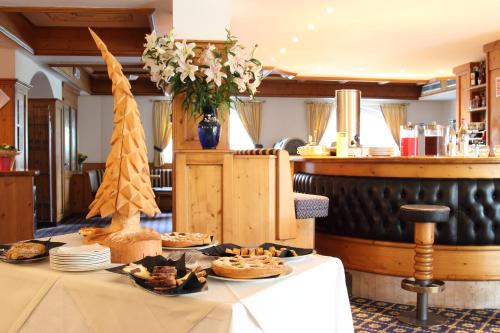 a table with food on it in a restaurant at Hotel Fanes Suite & Spa in Moena