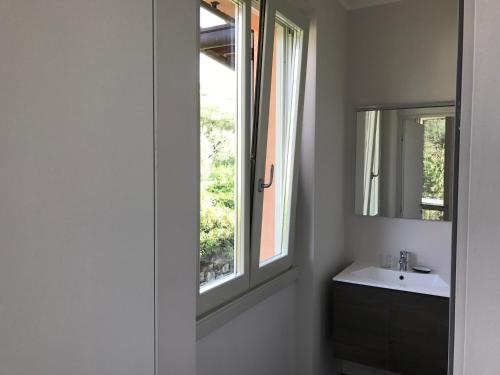 ベッラージョにあるCasa Oleandroのバスルーム(洗面台、窓付)