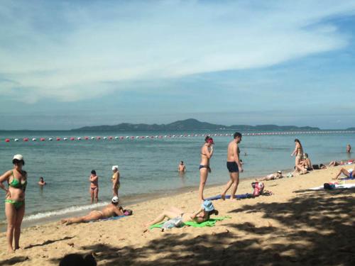 a group of people on the beach in the water at View Talay 5C in Pattaya South