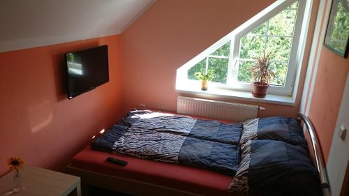 a small bedroom with a bed and a window at Nocleh na Jihu in Veselí nad Moravou