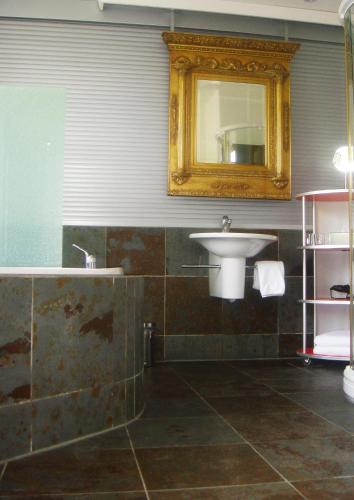 a bathroom with a sink and a mirror at Hotel Krone Sihlbrugg in Sihlbrugg Dorf