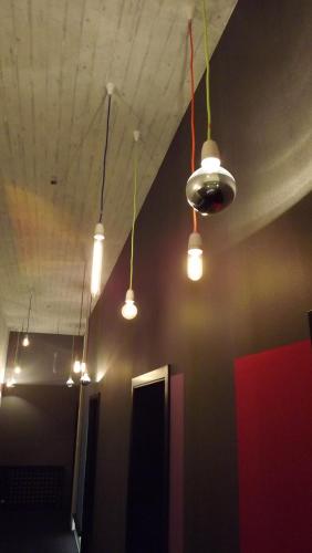 a room with several lights hanging from the ceiling at Hotel Cristall - Frankfurt City in Frankfurt/Main