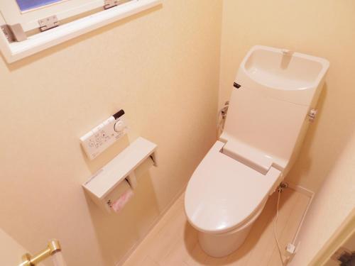 a bathroom with a white toilet in a room at Nao's Guesthouse 2 一軒家貸切 in Osaka