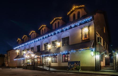a building with blue lights on it at night at Lepsza Садыба in Bila Tserkva