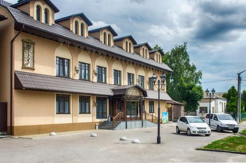 a building with a car parked in front of it at Lepsza Садыба in Bila Tserkva