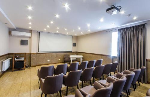 a conference room with chairs and a projection screen at Lepsza Садыба in Bila Tserkva