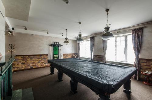 a large ping pong table in a room with windows at Lepsza Садыба in Bila Tserkva