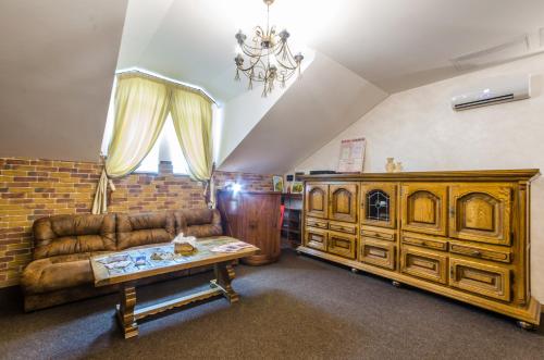 a living room with a couch and a table at Lepsza Садыба in Bila Tserkva