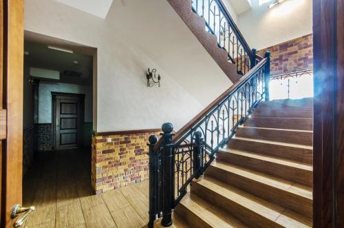 a staircase in a house with wooden floors and a door at Lepsza Садыба in Bila Tserkva