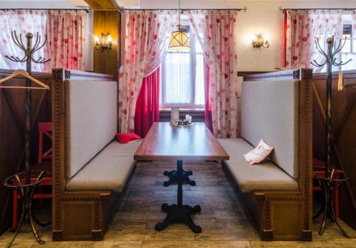a room with a table and a bench in it at Lepsza Садыба in Bila Tserkva