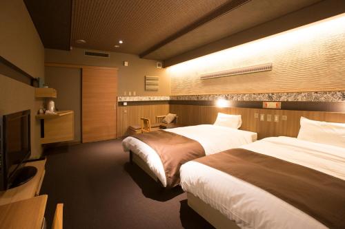 Un pat sau paturi într-o cameră la Wakkanai Grand Hotel