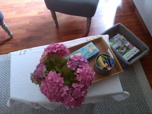 a bouquet of purple flowers sitting on a table at L'AURE BLEUE in Bayeux