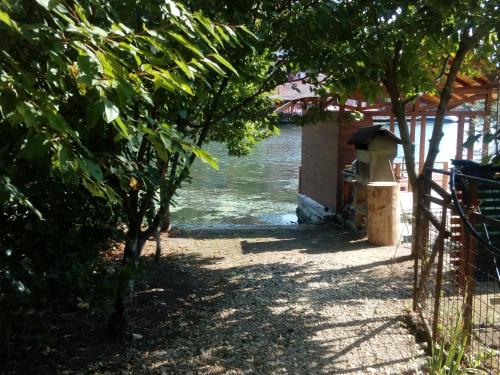 a path next to a body of water with trees at Casa Paty Orsova in Orşova