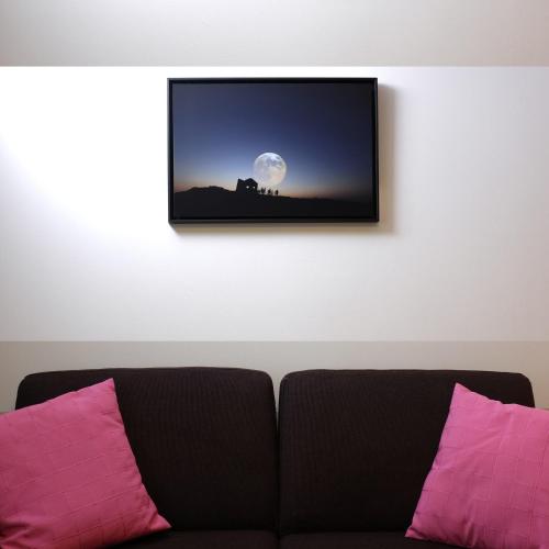 a picture hanging on a wall above a couch at Trinite Hotel in La Trinité-sur-Mer