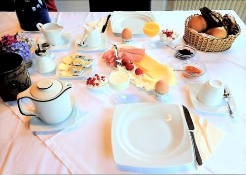 a table with a white plate of food on it at Beilsteiner Gästehaus in Beilstein
