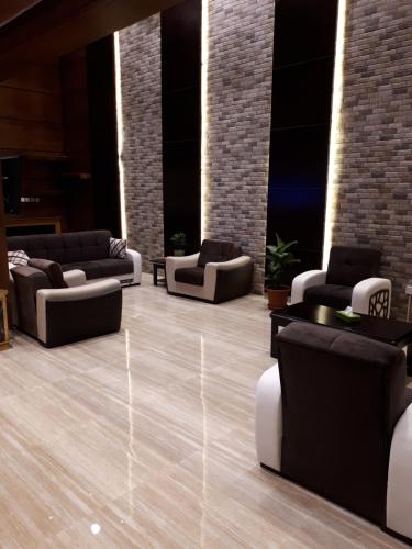 a lobby with couches and chairs in a building at تاج الخليج للشقق المخدومة in Dammam