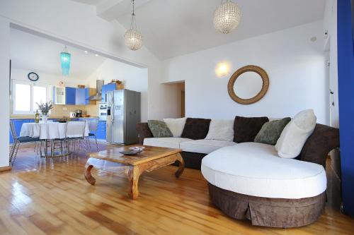 a living room with a couch and a table at Punta Preko Apartments in Preko