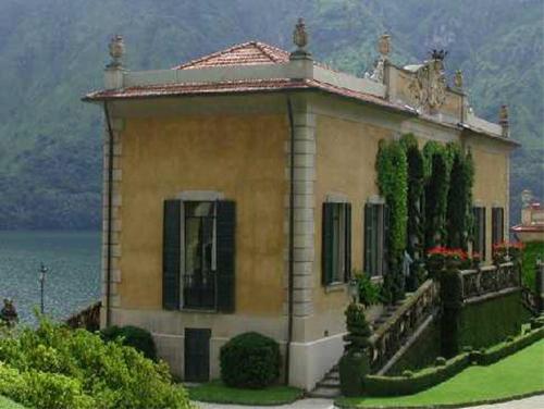 a house on the side of a lake with at Hotel Riviera in Griante Cadenabbia