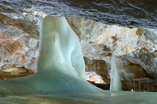 a large ice cave with a waterfall in the background at Apartmány Planina Predná Hora in Predná Hora