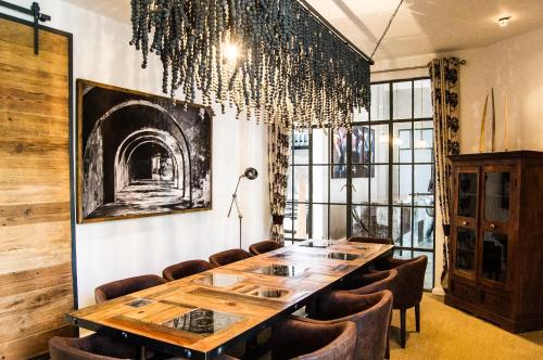a dining room with a long table and chairs at Latitude 15 Degrees in Lusaka