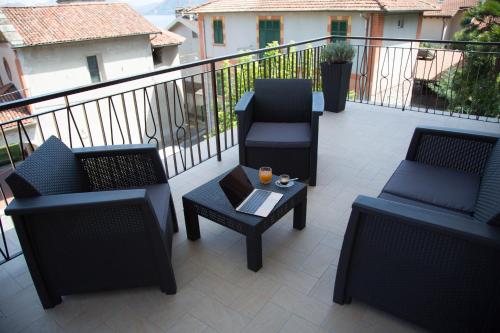 a balcony with two chairs and a table with a drink on it at Fruit'n Joy in Stresa